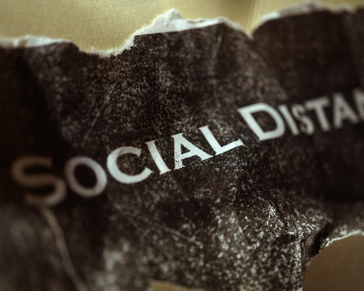 A crumpled piece of paper that reads "Social Distancing"
